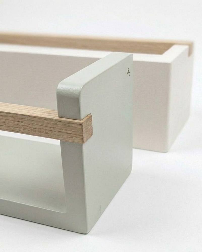 Close-up of a wooden shelf with a white background