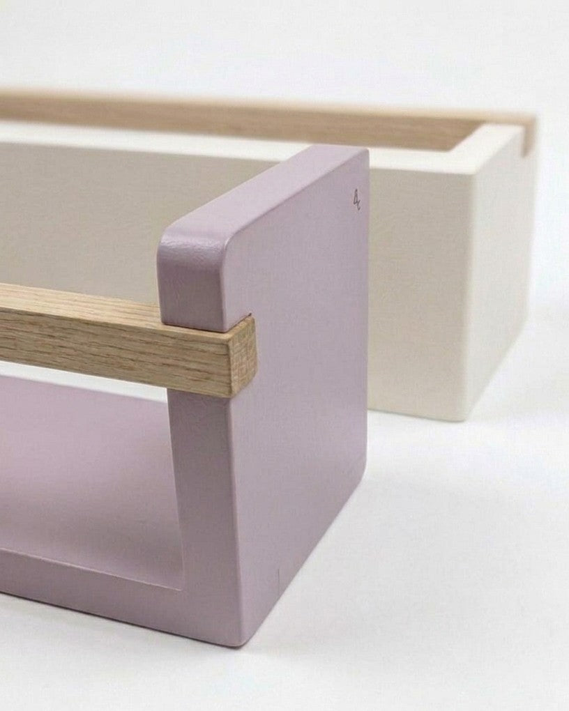 Minimalist furniture piece with lilac base and wooden frame on a white background