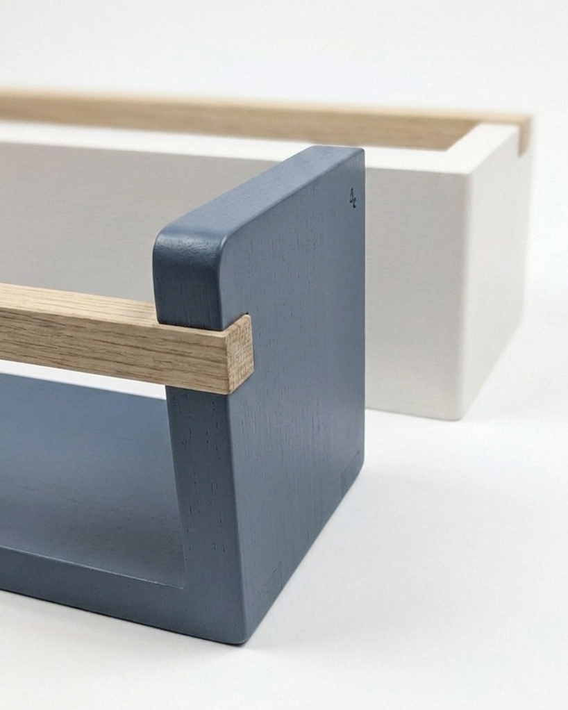 Modern furniture piece with blue corner and wooden edges on a white background
