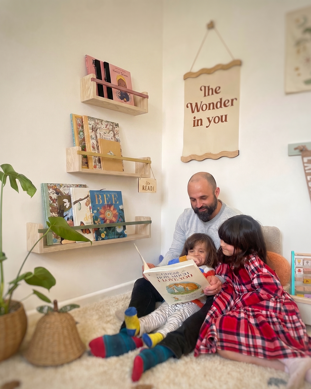 Father reading to young child beside The Story Shelf by Autumn's Corner, handcrafted in Wales