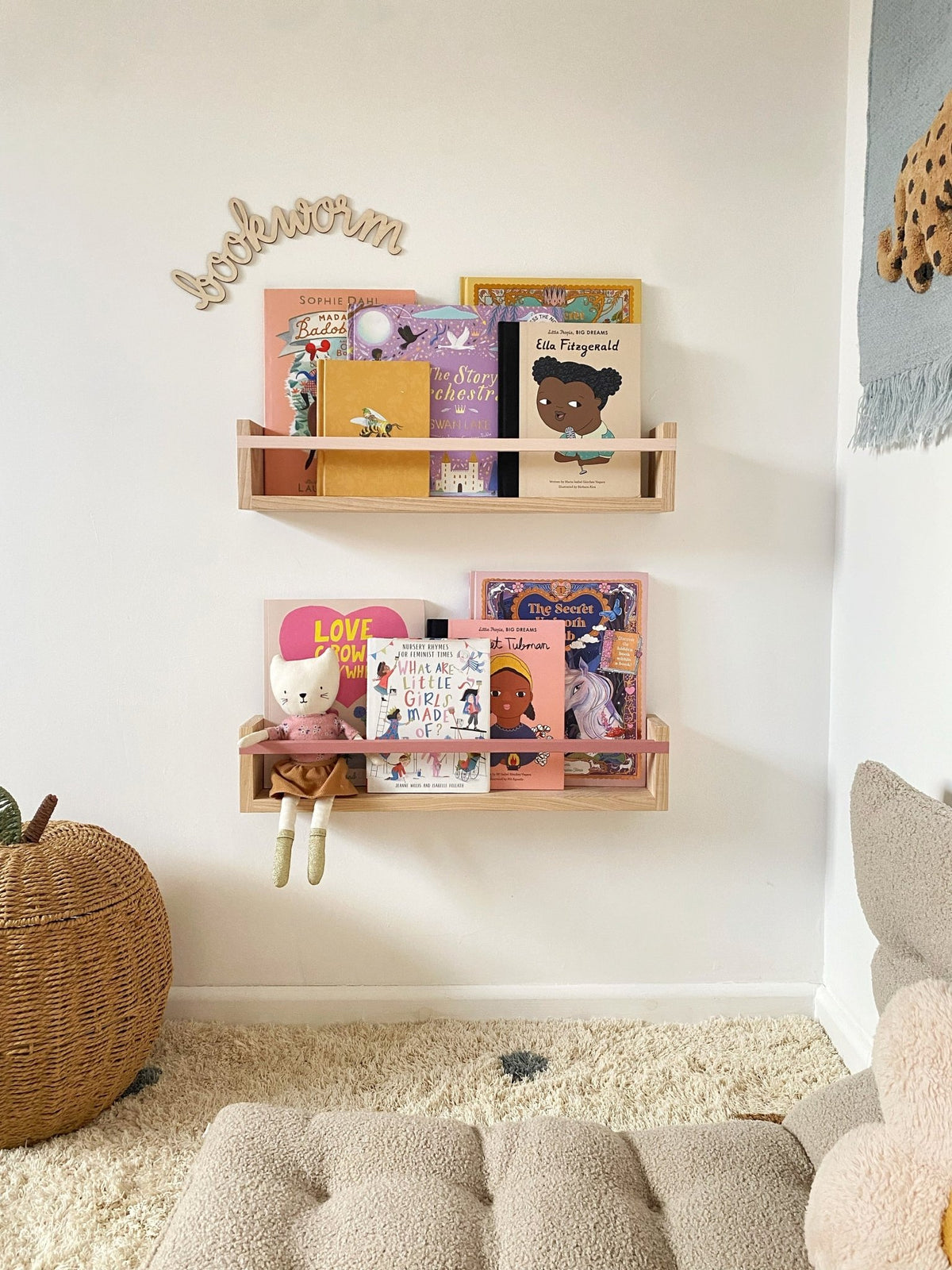 Two Bookshelf Classic shelves by Autumn's Corner above a cosy floor cushion, filled with front-facing picture books