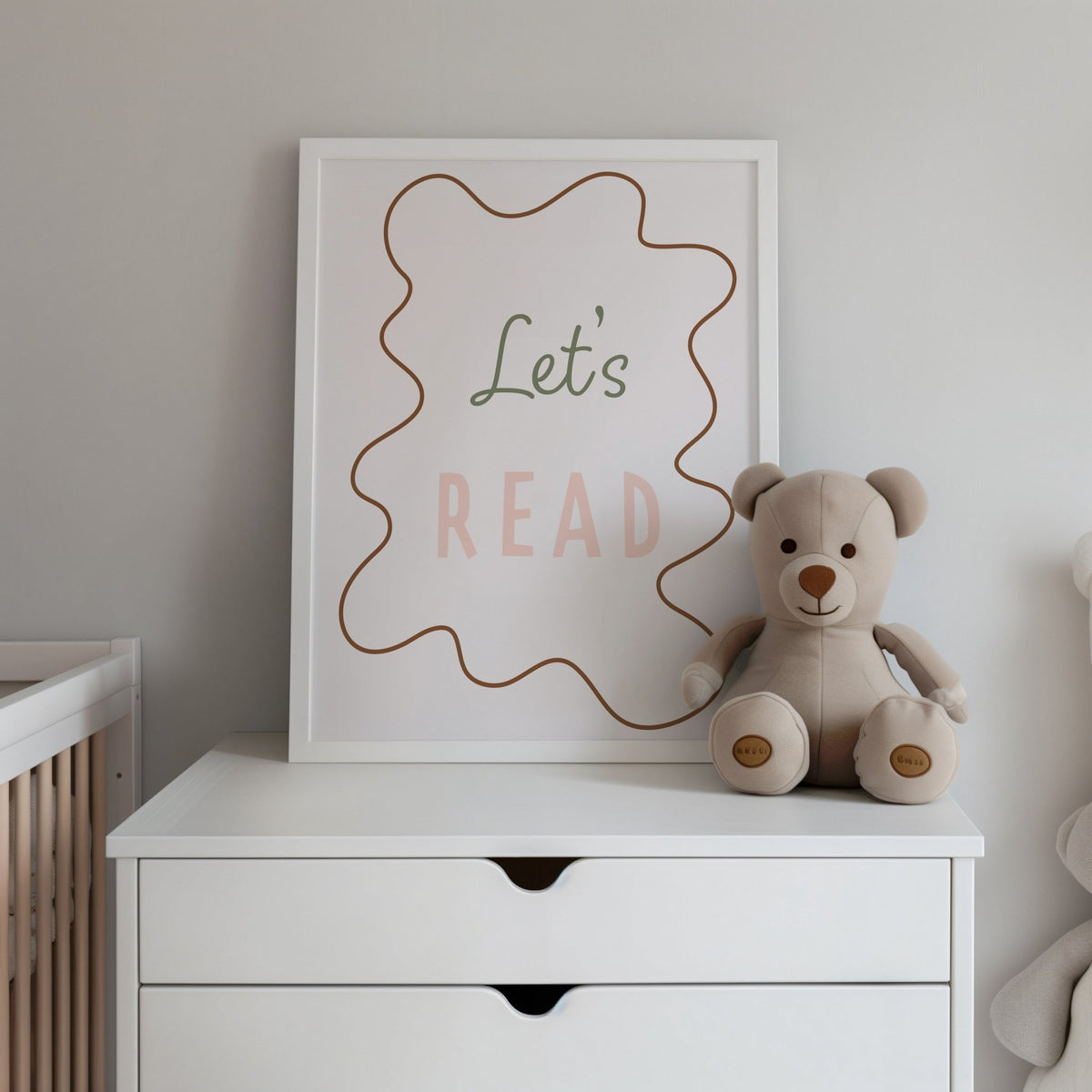 Let's Read Wavy Edition Print shown framed on a nursery chest of drawers beside a teddy