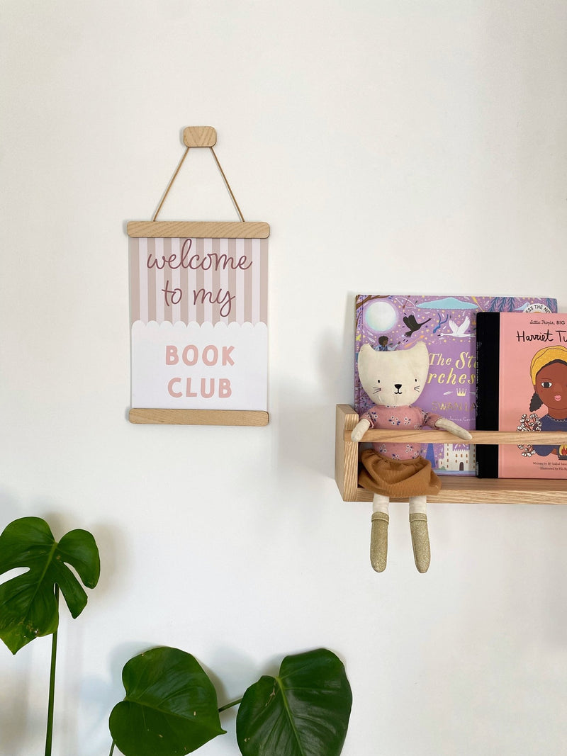 Straight Ash Magnetic Picture Frame with a Welcome to my Book Club print beside a bookshelf, handmade in Cardiff by Autumn's Corner